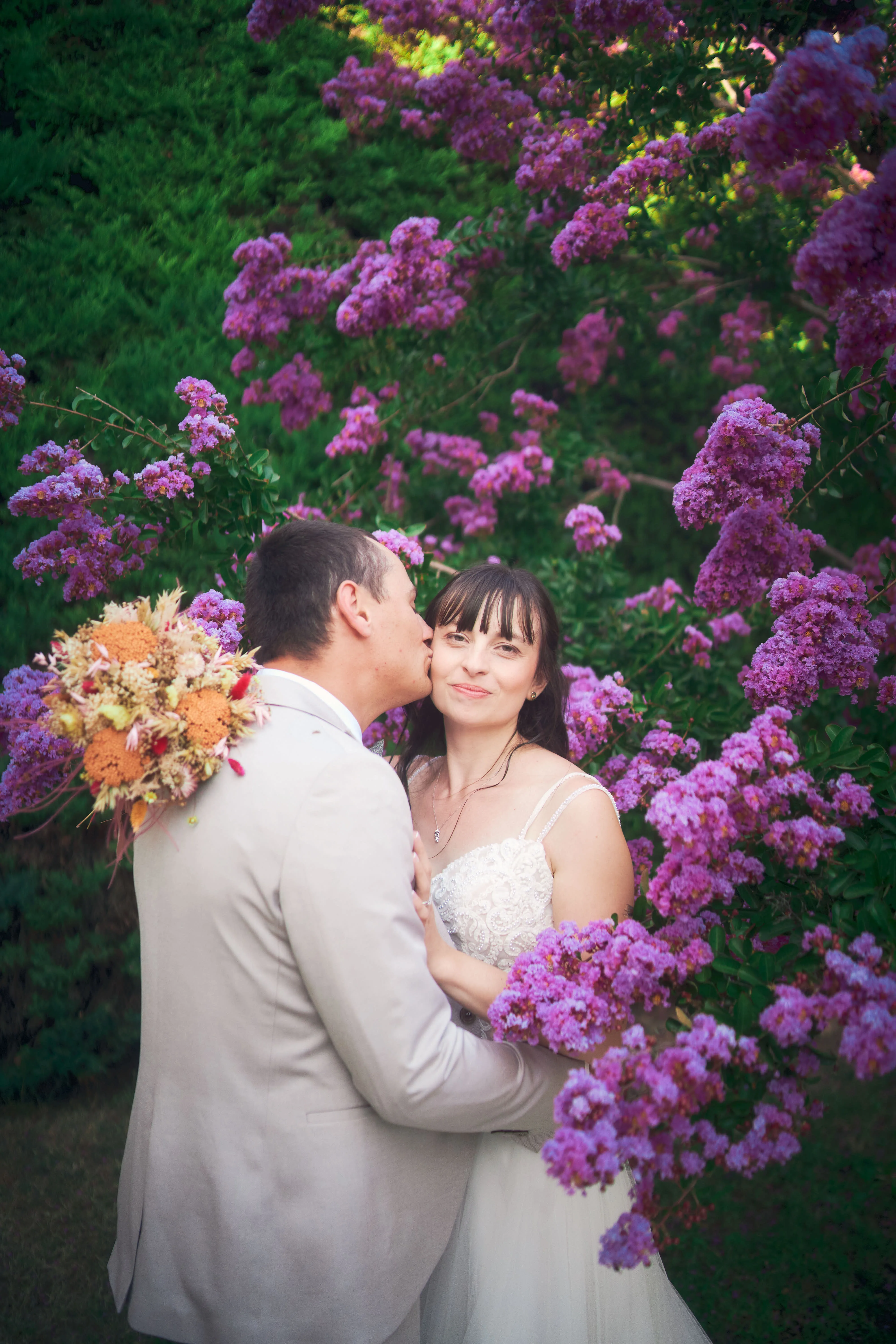 Portrait de couple de mariés dans un champ fleuri.